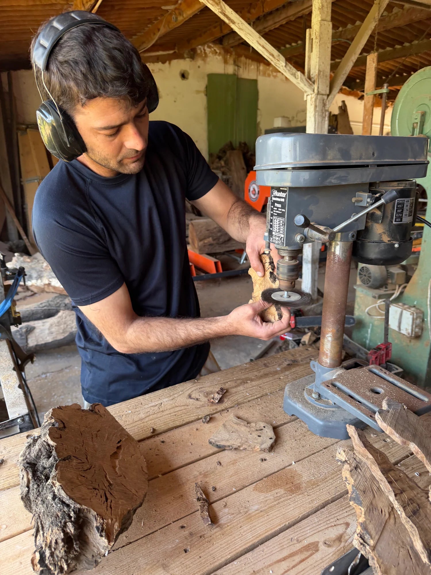 Eial Ovin working with olive wood at his workshop drill press