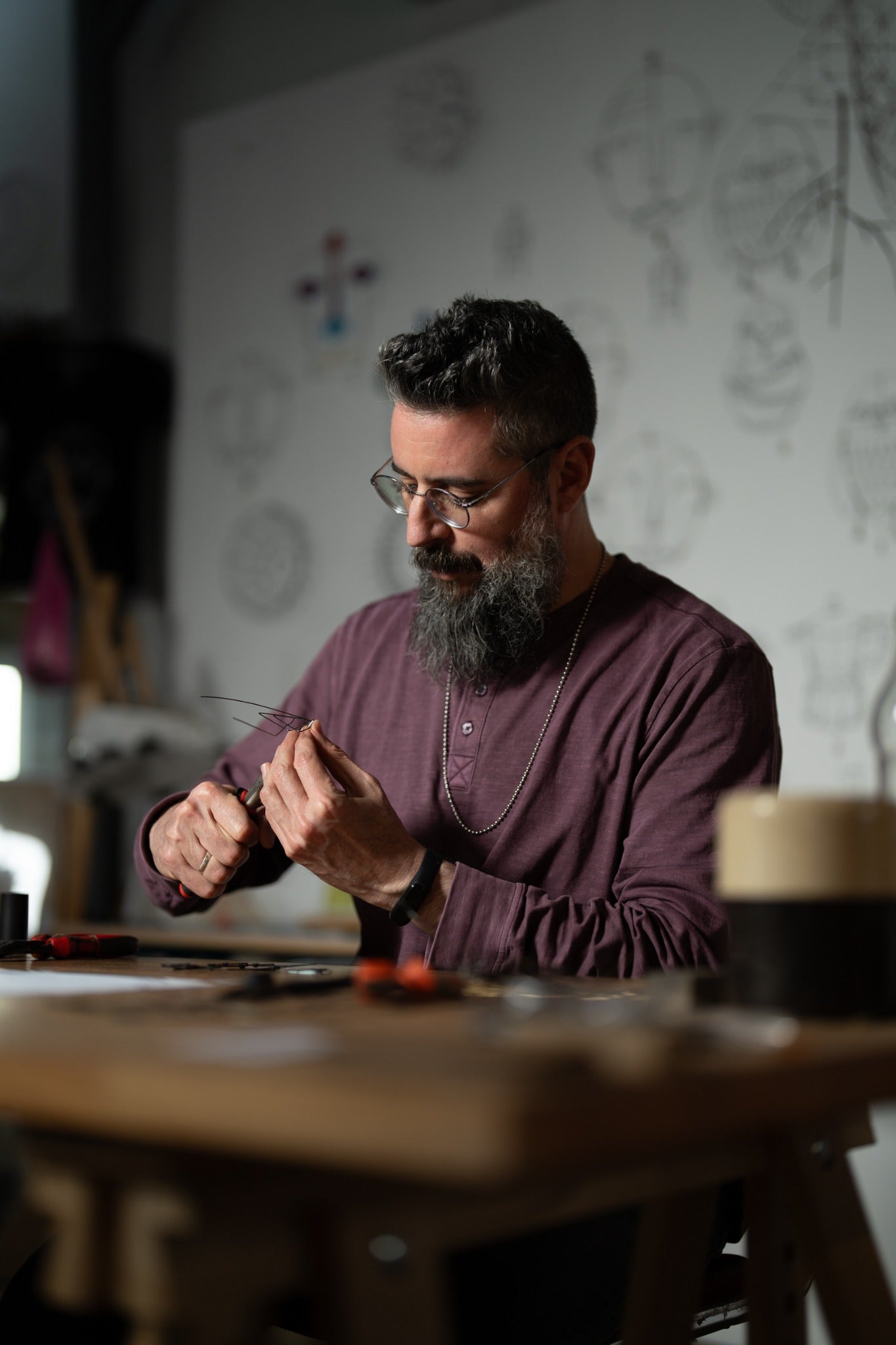 Koby Sibony shaping iron wire by hand in his studio